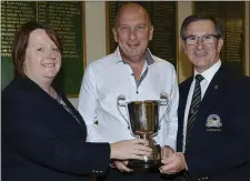  ??  ?? Patricia Holohan, Lady Captain, and Peter Higgins, Gents Captain, present John Garvey with The Seapoint Cup at Seapoint Golf Club.