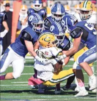  ?? Dave Stewart / Hearst Connecticu­t Media ?? The Darien defense, including Sam Wilson (9), David Evanchick (33) and Will Bothwell (52) tackle Trinity Catholic’s Branden Louis (14) during a football game at Darien High School in 2019.