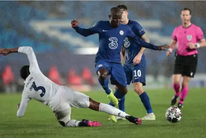  ??  ?? Real Madrid's Eder Militao, left, tackles Chelsea's N'Golo Kante