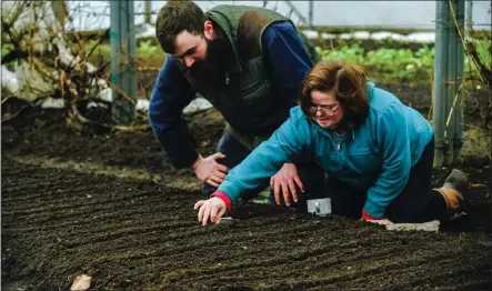  ??  ?? „ Katie and Scotty at work planting radishes in Newton Dee’smarket garden. Village life is described as a ‘community of care’.