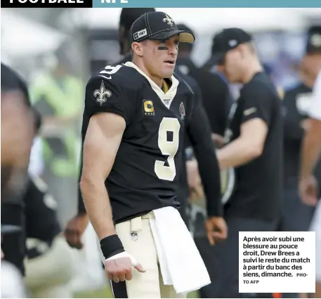  ?? AFP PHOTO ?? Après avoir subi une blessure au pouce droit, Drew Brees a suivi le reste du match à partir du banc des siens, dimanche.