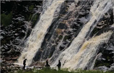  ??  ?? Gardaí searching the scene after remains were discovered at Glenmacnas­s Waterfall in June 2017.