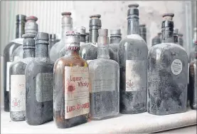  ??  ?? The hidden stash of empty whisky bottles Allan found inside his wall