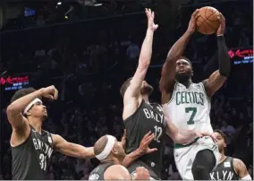  ?? PHOTO BY MARY ALAFFER, THE ASSOCIATED PRESS ?? Boston Celtics guard Jaylen Brown (7) goes to the basket against Brooklyn Nets center Jarrett Allen (31) forward Jared Dudley (6) and forward Joe Harris (12) during the second half of an NBA basketball game, Saturday, March 30, 2019, in New York. The Nets won 110-96.