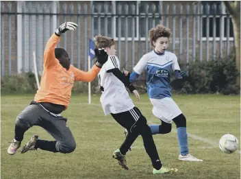  ??  ?? Goalmouth action from the Under 13 (9v9) game between Peterborou­gh Northern Star and Feeder Soccer. Star won 10-1.