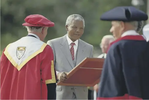  ??  ?? 0 Nelson Mandela, seen here receiving an honorary degree, visited Glasgow to accept the freedom of the city in 1993