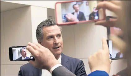  ?? JEFF CHIU — THE ASSOCIATED PRESS POOL PHOTO ?? Democratic candidate Gavin Newsom speaks with reporters after a California gubernator­ial debate with Republican candidate John Cox at KQED Public Radio Studio in San Francisco on Monday.