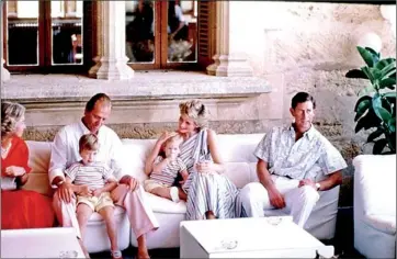  ??  ?? Distant: Prince Charles stares into the distance in this 1986 photograph showing him, Diana and the young Princes William and Harry with Queen Sofia and King Carlos of Spain