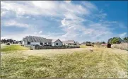  ??  ?? The backyard is partially fenced, has a newer yard barn/ shed at rear of property.