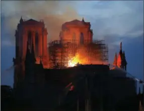  ?? MICHEL EULER — THE ASSOCIATED PRESS ?? Firefighte­rs tackle the blaze Monday as flames and smoke rise from Notre Dame cathedral as it burns in Paris.