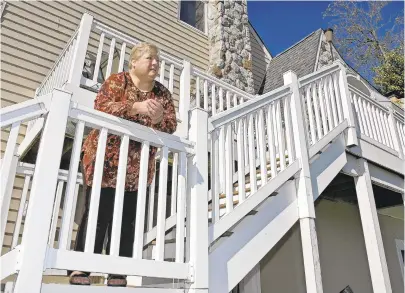  ?? PAULW. GILLESPIE/CAPITAL GAZETTE PHOTOS ?? Eileen Thaden on the stairs of her rebuilt home, which has been elevated even higher than the one that was destroyed when the remnants of Hurricane Isabel hit the area in 2003.