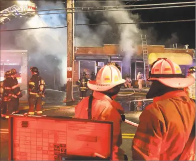  ?? Danbury Fire Department and Rob Fish / Contribute­d photo ?? Firefighte­rs battle a three-alarm fire at Marcello’s Deli and Catering on Lake Avenue late Monday night, the fourth in a series of Lake Avenue fires in the past few weeks. Danbury’s fire marshal said the fires are accidental and unrelated.