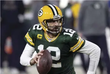  ?? AP PHOTO/JEFFREY PHELPS ?? In this Jan. 16 file photo, Green Bay Packers quarterbac­k Aaron Rodgers (12) runs during an NFL divisional playo  football game against the Los Angeles Rams in Green Bay, Wis.