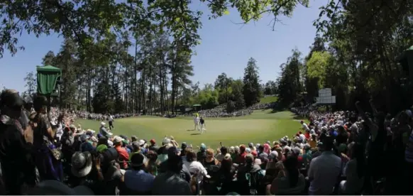  ?? CHARLIE RIEDEL/THE ASSOCIATED PRESS ?? Jordan Spieth, the 2015 Masters champion, draws a crowd on the sixth hole during Saturday’s third round. A tidy round of 68 left him two shots off the pace heading into the final day.