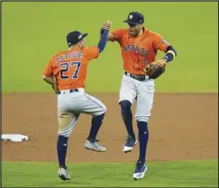  ?? Associated Press ?? EXTEND — Houston Astros’ Carlos Correa (1) celebrates with Jose Altuve after winning Game 6 of the American League Championsh­ip Series on Friday in San Diego. The Astros defeated the Rays 7-4 to tie the series 3-3.