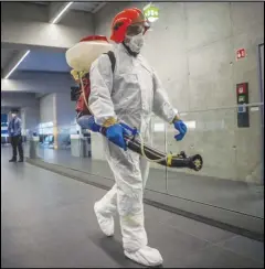  ?? ASSOCIATED PRESS ?? Disinfecti­on equipment is carried by a worker Wednesday as a precaution­ary measures against the spreading of novel coronaviru­s at Budapest Liszt Ferenc Internatio­nal Airport in Budapest, Hungary.