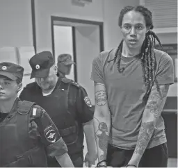  ?? ALEXANDER ZEMLIANICH­ENKO/AP ?? WNBA star Brittney Griner is escorted from a courtroom after a hearing Aug. 4 in Khimki, just outside Moscow.