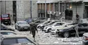  ?? AP/PTI ?? A police officer walks at a parking where cars were damaged during Russian attack in Kyiv on Tuesday