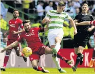  ??  ?? CLOSEST RIVALS Dons’ Shinnie, left, tackles Celt Tierney