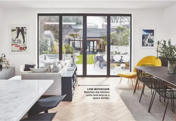  ??  ?? LOW BOOKCASE MATCHES THE KITCHEN UNITS AND ACTS AS A SPACE DIVIDER