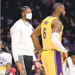  ?? ASHLEY LANDIS AP ?? Lakers’ Anthony Davis (left), talking with Lebron James on Wednesday in Indiana, will be a game-decision to play against the Miami Heat tonight.