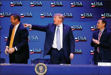  ?? JOHN LOCHER / ASSOCIATED PRESS FILE (2018) ?? Then-president Donald Trump attends a roundtable discussion with Dean Heller, left, and Adam Laxalt on June 23, 2018, in Las Vegas.