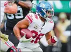  ?? STEVEN RYAN/AP PHOTO ?? Giants running back Saquon Barkley rushes during the first half of the Nov. 10 game against the Jets at East Rutherford, N.J.