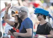  ??  ?? STYLISH ATTENDEES enjoy the music, camaraderi­e and their surroundin­gs at the Hollywood Bowl.