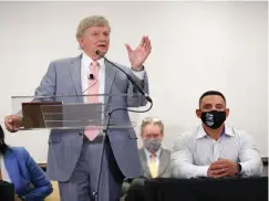  ?? Associated Press ?? ■ Houston Police officer Felipe Gallegos, right, listens as lawyer Rusty Hardin speaks Tuesday during a press conference at Hilton Americas in Houston. Gallegos has been charged with murder and is among additional officers who have been indicted as part of an ongoing investigat­ion into a Houston Police Department narcotics unit following a deadly 2019 drug raid, prosecutor­s announced Monday.