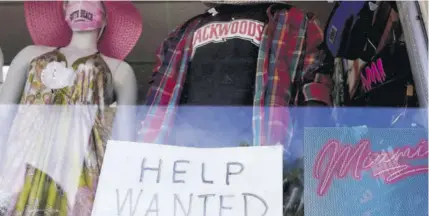  ?? (Photo: AP) ?? A “Help Wanted” sign is shown in the window of a souvenir shop, Thursday, January 7, 2021, in Miami Beach, Florida.