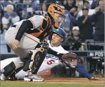  ?? Wally Skalij Los Angeles Times ?? COREY SEAGER slides into home ahead of the throw to Giants catcher Buster Posey to give the Dodgers their first run.