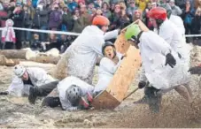  ?? Jeremy Papasso, Daily Camera file ?? Kim Childress, with Team Nerds, goes down in the coffin with the rest of her team as they crash during the 2017 Frozen Dead Guy Days coffin races in Nederland.