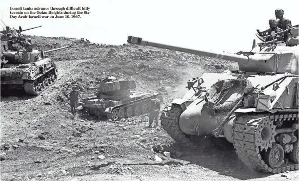  ?? GERSHON YUVAL, AFP/GETTY IMAGES ?? Israeli tanks advance through difficult hilly terrain on the Golan Heights during the SixDay Arab-Israeli war on June 10, 1967.