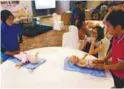  ??  ?? Nurses from Pantai Hospital Cheras demonstrat­e how mums and dads can massage their babies.