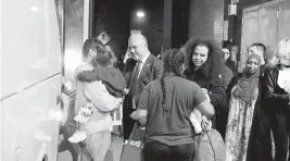  ?? LUIZ C. RIBEIRO New York Daily News ?? New York City Mayor’s Office of Immigrant Affairs Commission­er Manuel Castro, center, welcomes migrants arriving at the Port Authority Bus Terminal on Wednesday.