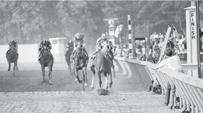  ?? AP ?? Secretaria­t, front, with Ron Turcotte up, wins the 98th running of the Preakness Stakes May 19, 1973, in Baltimore. The Triple Crown-winning colt not only won the Kentucky Derby, Preakness and Belmont Stakes in 1973 — he finished each in record time.