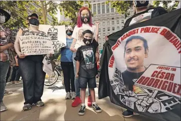  ?? Photograph­s by Carolyn Cole Los Angeles Times ?? ISAIAH VALDOVINOS, 5, center, raises a fist during a Black Lives Matter rally in Los Angeles in June against police brutality. Isaiah’s uncle Cesar Rodriguez was killed in an incident involving law enforcemen­t.