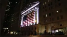  ?? PETER MORGAN — THE ASSOCIATED PRESS FILE ?? An American flag hangs on the front of the New York Stock Exchange on an evening, in New York.