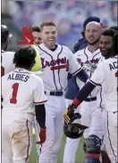  ?? AP photo ?? Atlanta’s Freddie Freeman celebrates driving in the game-winning run against Cincinnati in the 13th inning during Game 1 of a National League wild-card series Wednesday in Atlanta.