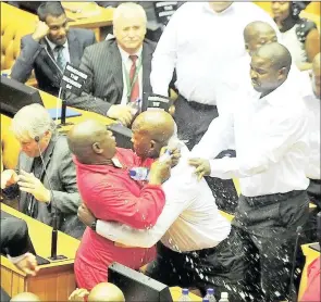  ??  ?? GIVEN THE BOOT: EFF MP Godrich Gardee is removed from the National Assembly by the protection unit.