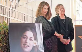  ?? CHRIS PIZZELLO/INVISION/AP ?? Owen Elliot-kugell, daughter of Cass Elliot, looks at a portrait of her mother as she stands with her aunt Leah Kunkel in 2022.