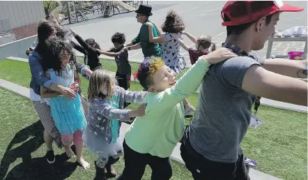  ??  ?? Campers and camp counsellor­s dance at the Bay Area Rainbow Day Camp in El Cerrito, Calif. It’s one of the only camps of its kind in the world open to preschoole­rs. Enrolment is now 60.