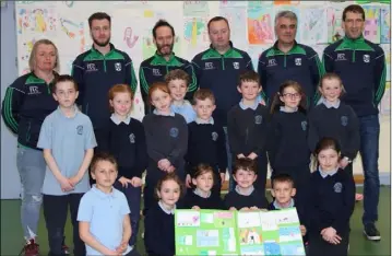  ??  ?? Members of the Geraldines coaching team with pupil from St Oliver Plunkett NS.