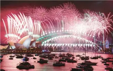  ?? DAVID GRAY/GETTY-AFP ?? New Year’s Eve fireworks light up the sky Sunday over the Opera House and Harbor Bridge in Sydney.