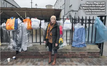  ?? PETER MORRISON ?? Marney Magee with clothes on the railings of St Mary’s Church in Chapel Lane for homeless and
needy