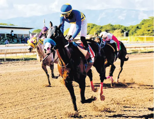  ?? ANTHONY MINOTT/FREELANCE PHOTOGRAPH­ER ?? I’VE GOT MAGIC, ridden by Tevin Foster, wins The Alexander Hamilton Memorial Trophy over a mile at Caymanas Park yesterday.