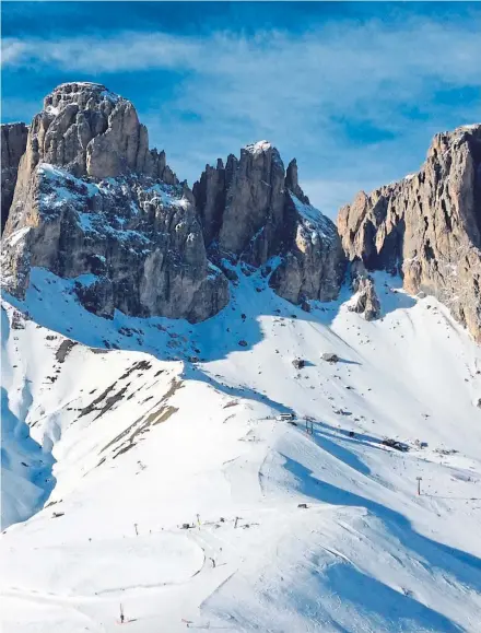  ??  ?? ● The spectacula­r jagged peaks of the Dolomites tower over so many fantastic ski runs