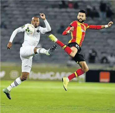  ?? Picture: Gallo Images ?? Xola Mlambo of Orlando Pirates and Chalali Ghilane of Esperance battle for the ball during their Caf Champions League match at Orlando Stadium last night.