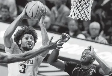  ?? CARLOS GONZALEZ/TRIBUNE NEWS SERVICE ?? Jordan Murphy (3) attempts a shot in the first half against Miami on Wednesday in Minneapoli­s, MN.