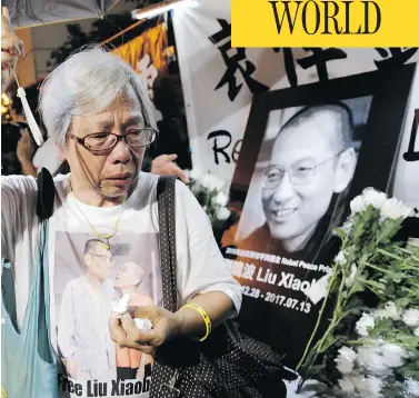  ?? KIN CHEUNG /THE ASSOCIATED PRESS ?? A protester mourns the death of Chinese dissident and Nobel laureate Liu Xiaobo during a demonstrat­ion outside the Chinese liaison office in Hong Kong on Thursday. Liu died Thursday in state custody at age 61.